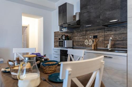 a kitchen with a table with two chairs and a counter top at Agriturismo Why Farm in Marano Ticino