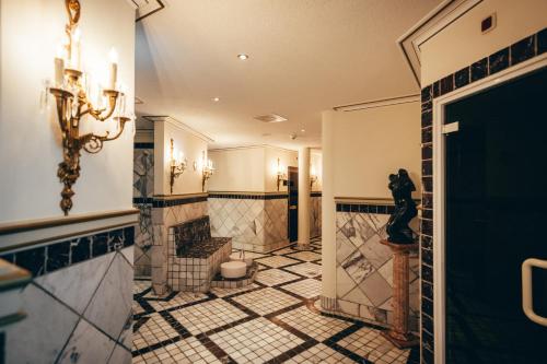 a bathroom with a toilet and a tiled floor at Schloss Lieser, Autograph Collection in Lieser