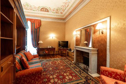 a living room with a couch and a fireplace at Phi Hotel Principe in Cuneo