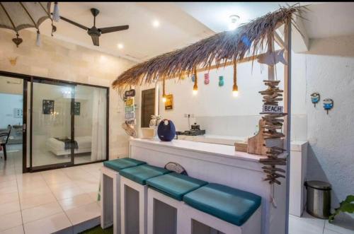 a bathroom with a counter with a sink and a tub at Villa casa in Seminyak