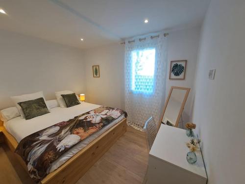 une chambre avec un lit, une table et une fenêtre dans l'établissement Appartement T2 rez-de-villa, à Furiani