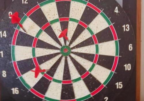 a close up of a dartboard with darts at Rosewood by Nature Resorts and Stays in Ooty