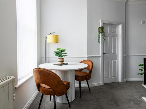 a dining room with a white table and chairs at Abdiel 5 · Bright Modern Marina Apt Newly Refurbished Pass the Keys in Hartlepool