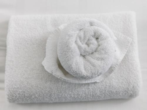a roll of white towels with a donut on it at Abdiel 6 · Stylish 1st-Floor Retreat by Hartlepool Marina Pass the Keys in Hartlepool