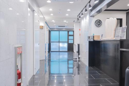 a hallway in a building with a clock on the wall at Minutes from Sumiyoshi & Iconic Attractions & Sky Tree in Tokyo