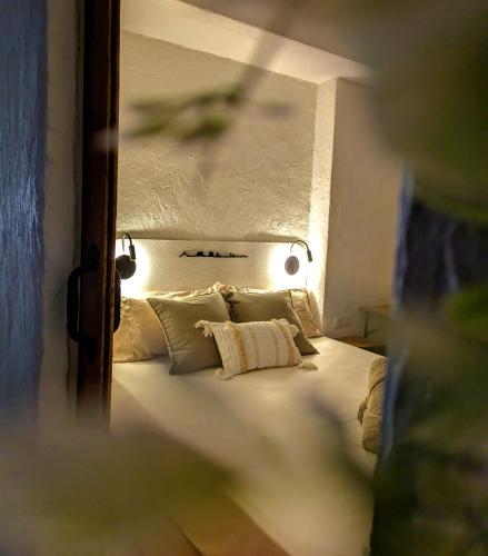 a bedroom with a bed with white sheets and pillows at Casa San Pedro 3 in Murcia