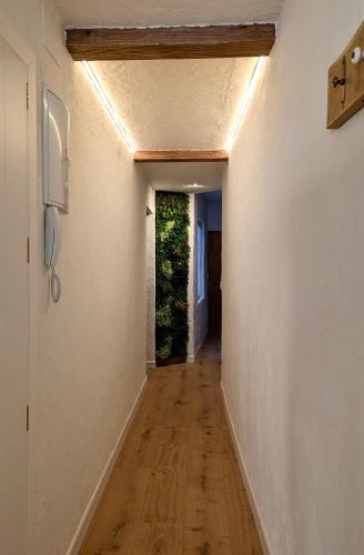 a hallway with white walls and a wooden floor at Casa San Pedro 3 in Murcia