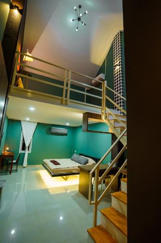 a room with a bunk bed and a staircase at Standard in Ban Phrom Min