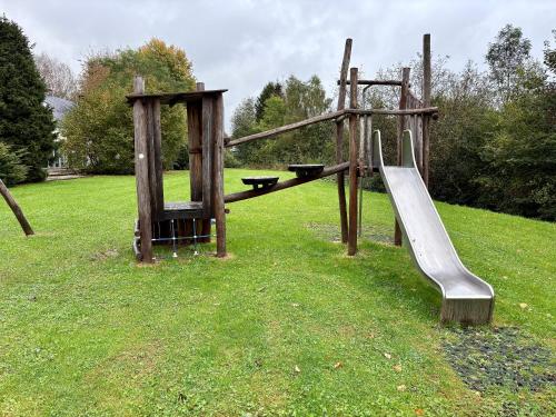 a playground with a slide in the grass at Chez Dom in Malmedy