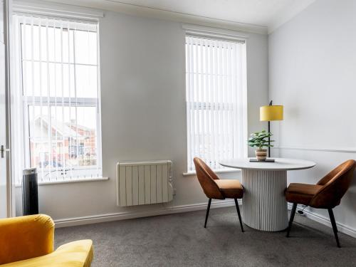 a white room with a table and chairs and windows at Abdiel 5 · Bright Modern Marina Apt Newly Refurbished Pass the Keys in Hartlepool