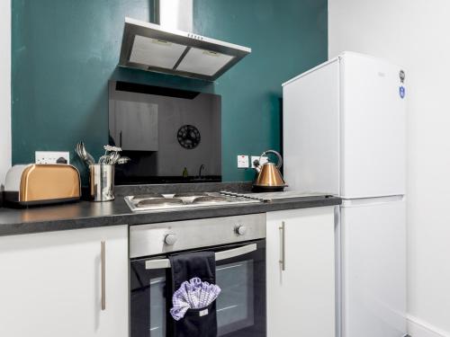 a kitchen with white cabinets and a stove top oven at Abdiel 5 · Bright Modern Marina Apt Newly Refurbished Pass the Keys in Hartlepool
