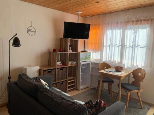 a living room with a couch and a table at Chasa Bazzi in Scuol