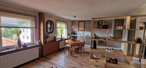 a kitchen with a table and chairs in a room at Vakantiehuis Ykema in Eisenschmitt