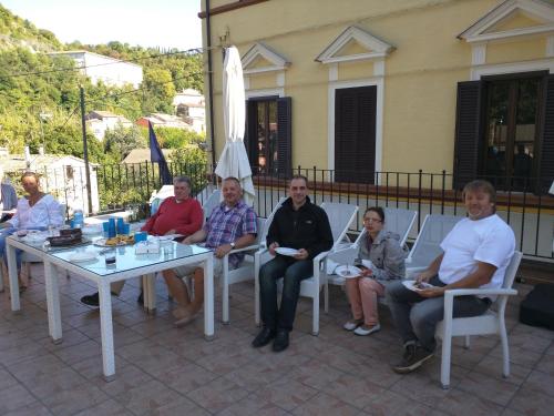 a group of people sitting around a table at Raffaello Residence in Sassoferrato