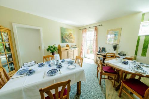 a dining room with two tables and chairs at Herberts Stubn in Feldkirchen bei Graz