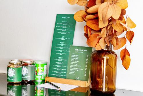 a vase with flowers in it next to some drinks at Royal Boutique Hotel in Cape Town