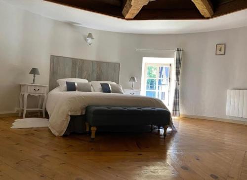 une chambre avec un grand lit et un parquet dans l'établissement Le Colombier d Yville, à Héronchelles