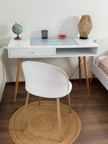 a white desk with a chair in a bedroom at L'Étoile du Langevin 450m Avenue Champagne in Épernay