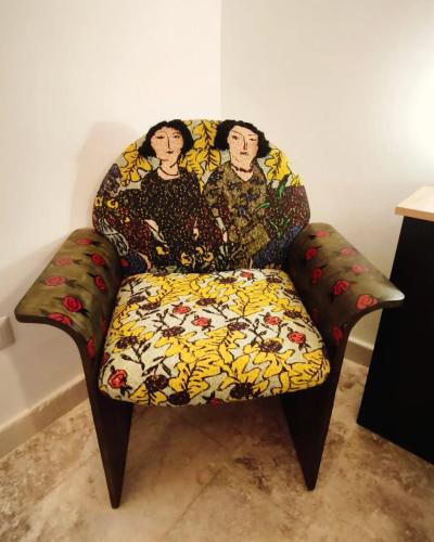 a couch sitting in a living room with a colorfulussion at Chez Liart 1 in Fasano