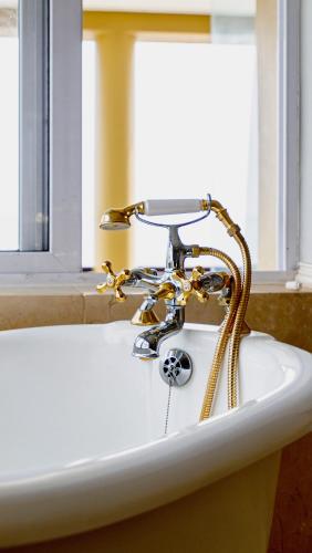a white sink with a faucet in a bathroom at Royal Boutique Hotel in Cape Town