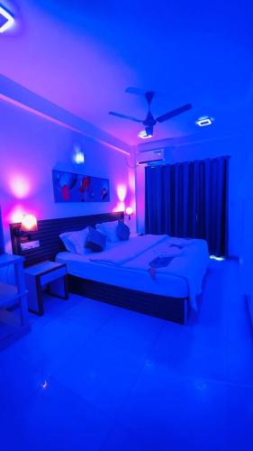 a bedroom with two beds in a blue room at HS Miracle Grand in Hulhumale