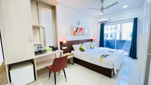 a hotel room with a bed and a window at HS Miracle Grand in Hulhumale