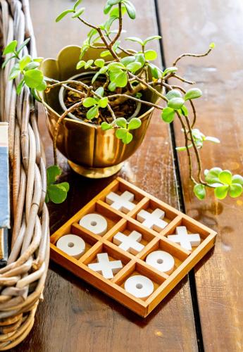 a wooden table with a game board and potted plants at Royal Boutique Hotel in Cape Town