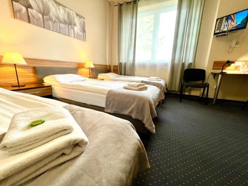Posteľ alebo postele v izbe v ubytovaní Hotel Seven 7