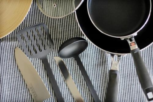 a group of kitchen utensils sitting on a table at Clio Matoba - Fully Equipped Studio Getaway in Hiroshima