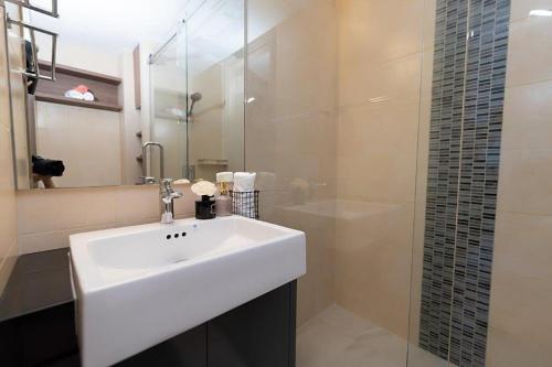 a bathroom with a sink and a glass shower at Escape condo E166 in Mae Pim
