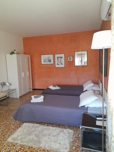 a bedroom with a large bed with blue sheets and pillows at Sweet House in Solesino