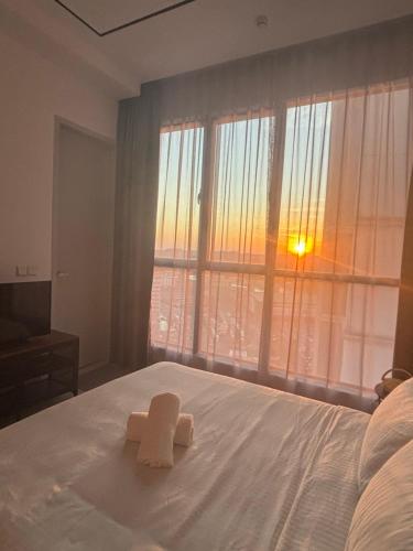 a bedroom with a bed with two towels on it at Skytrees Comfort Room With Simple Design Concept in Johor Bahru