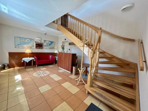 a living room with a staircase and a red couch at Reda in Mielno
