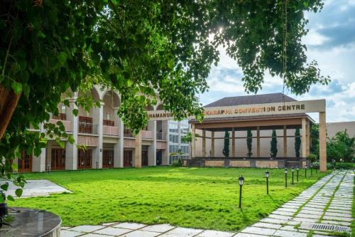 a building with a green lawn in front of it at Southern Star,Davangere in Dāvangere