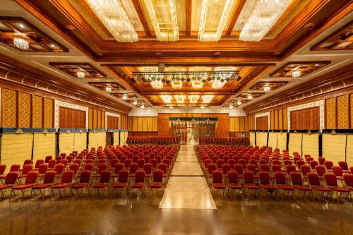 an empty auditorium with red chairs and a stage at Southern Star,Davangere in Dāvangere