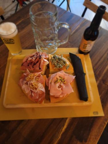 a plate of sushi with a knife and a bottle of wine at CORTE DELLA BIRRA - OLDO in Cadelbosco di Sopra