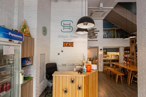a restaurant with a counter with spiders on the wall at Simply Sleep Hostel in Bangkok