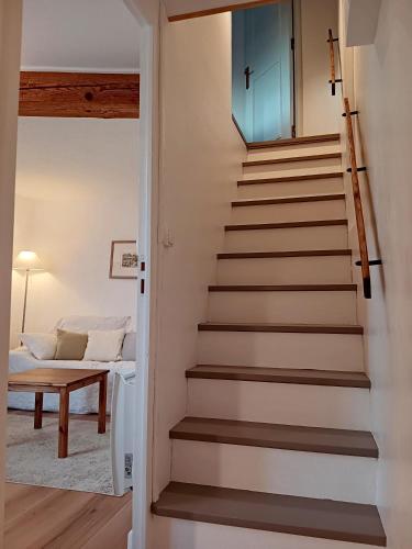 a staircase leading up to a room with a bed at La Petite Romance - Gîte 3 étoiles in Siran