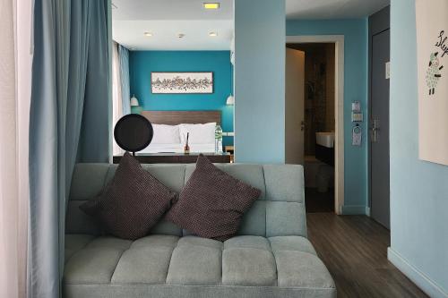 a living room with a couch and a bed at Simply Sleep Hostel in Bangkok