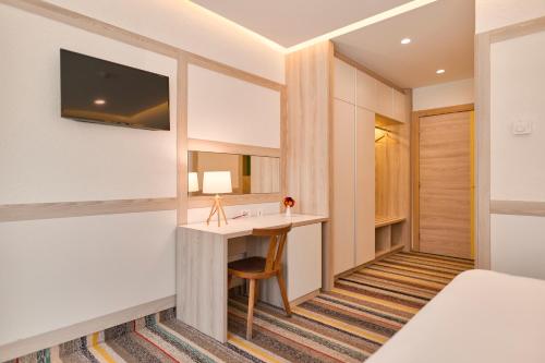 a hotel room with a desk and a bed at Hotel Han Bjelašnica in Bjelašnica