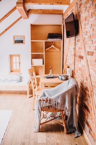 a room with a table and a brick wall at Villa Hubertus in Srebrna Góra
