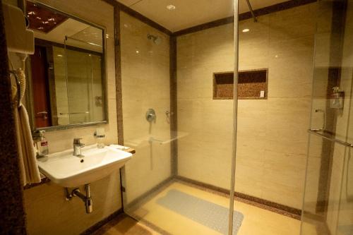 a bathroom with a sink and a shower at Southern Star,Davangere in Dāvangere