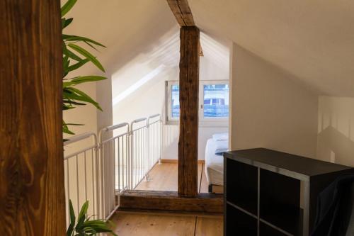 a room with a staircase with a window and a tv at HITrental Zeughausgasse - Apartment in Zug