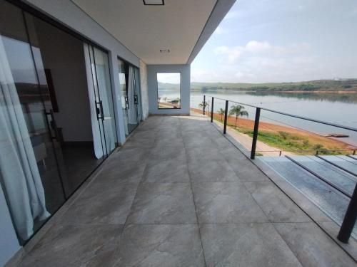 a balcony with a view of the water at Casa de Charme Camargos in São João del Rei