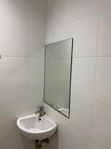 a white bathroom with a sink and a mirror at Rio Grande de Pampanga Villas in Fort Stotsenburg