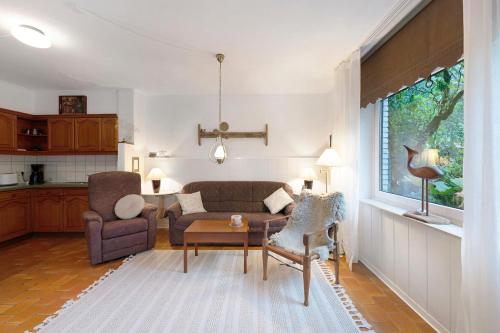 a living room with a couch and a table at Ferienwohnung Familie Franke in Joldelund