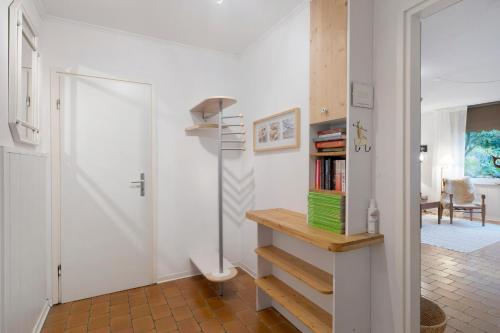 a room with a staircase and a book shelf at Ferienwohnung Familie Franke in Joldelund
