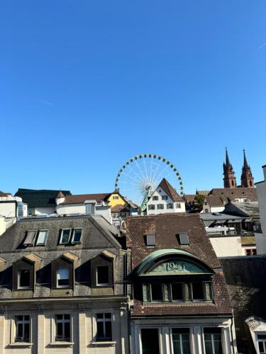 a ferris wheel in the background of a city at Exclusive Rooftop Duplex Penthouse - 200sqm - 280 Panoramic Views - Downtown in Basel