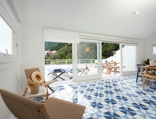 a living room with a blue and white tile floor at Casa Dalù in Positano
