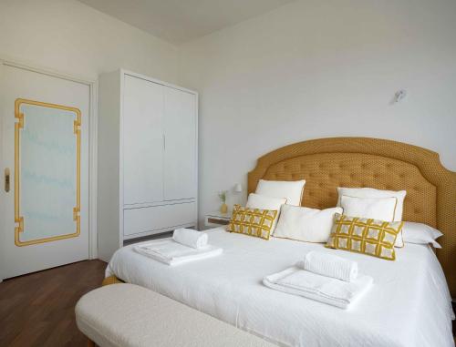 a large white bed with two pillows on it at Casa Dalù in Positano
